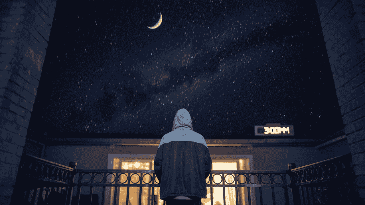 Person on a balcony at 3:00am, looking at a starry sky, symbolizing hope and alignment.