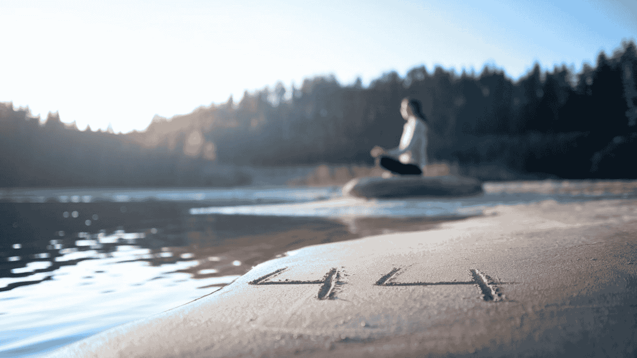 Person meditating outdoors with the number 444 subtly displayed in the background, symbolizing alignment and spiritual growth.