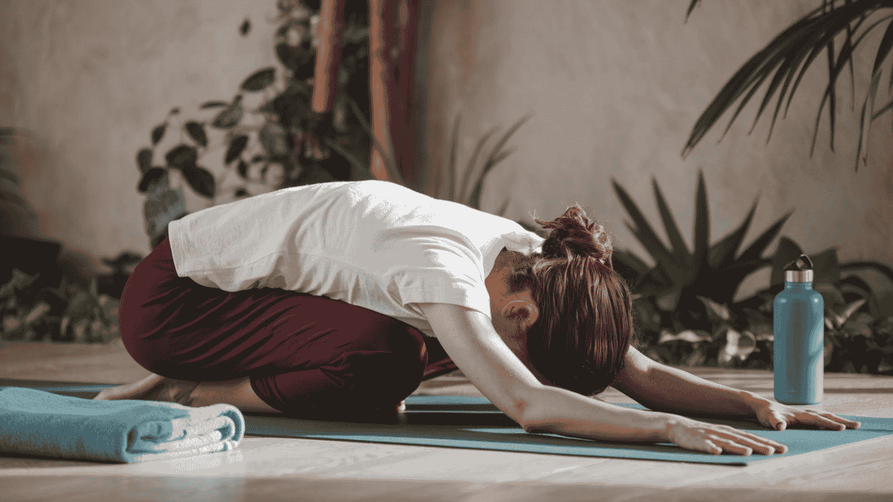 Yogi resting in Child’s Pose during a Bikram Yoga class, symbolizing the importance of listening to your body.